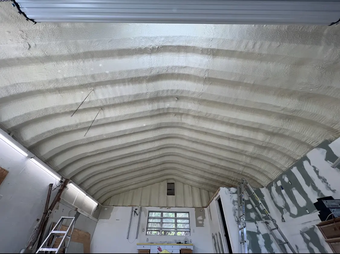 Spray polyurethane foam applied to the underside of a metal roof deck in Makakilo